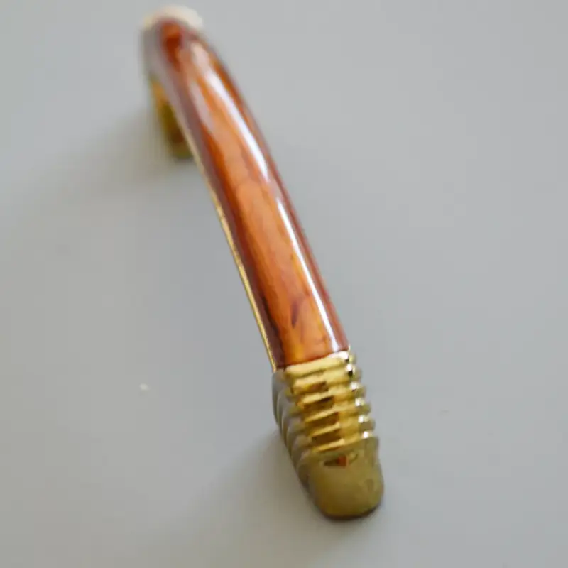 10 db Fém-műanyag bútorfogantyú, arany - mahagóni, 64 mm furattáv Utolsó esély