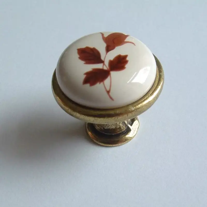 Porcelán-fém bútorgomb, fehér - bronz színű véggel, barna virág motívummal Azonnal elérhető